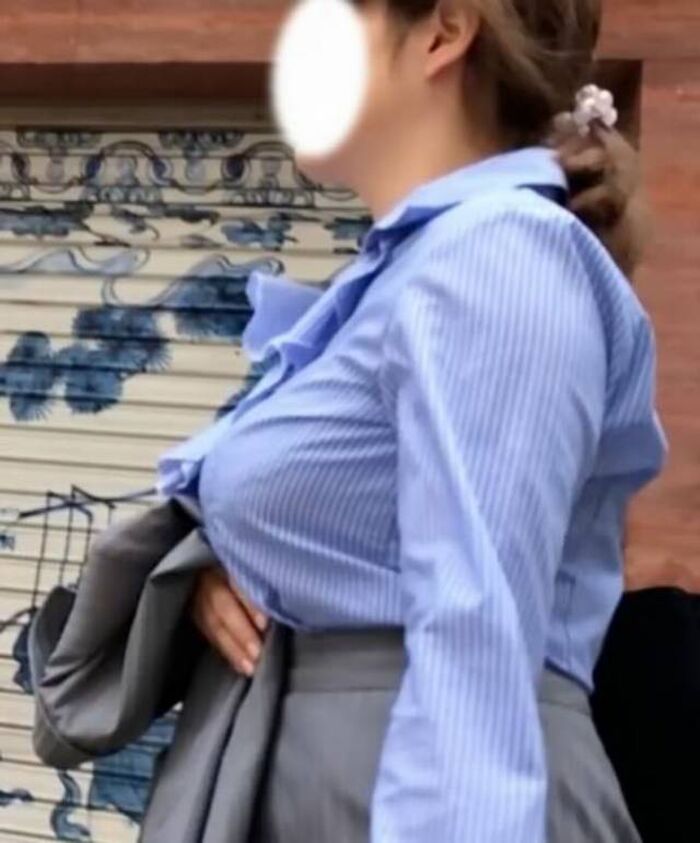 Photograph amateur girls dressed in clothes that look bigger than busty breasts in the city 9th image