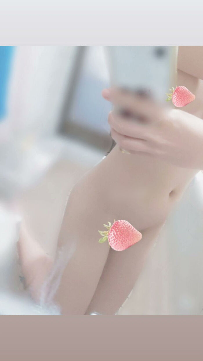 22-year-old female student holding a smartphone with her face and taking a naked hair nude mirror photo 11th image