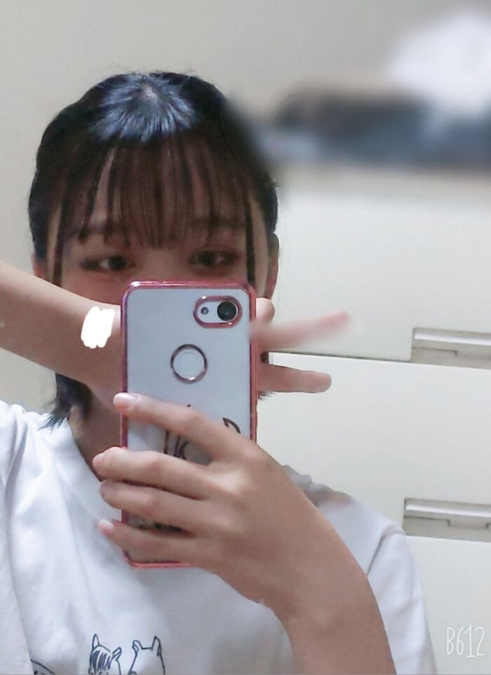 22-year-old female student holding a smartphone with her face and taking a naked hair nude mirror photo 15th image