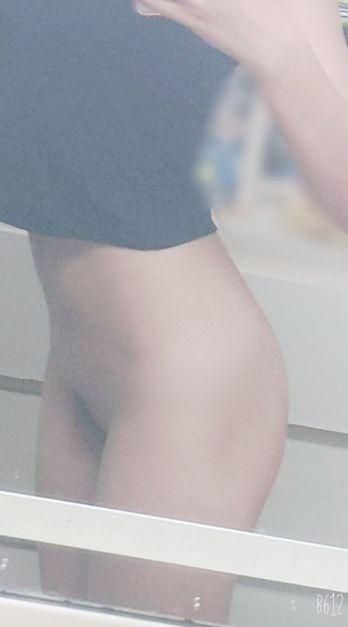 22-year-old female student holding a smartphone with her face and taking a naked hair nude mirror photo 20th image