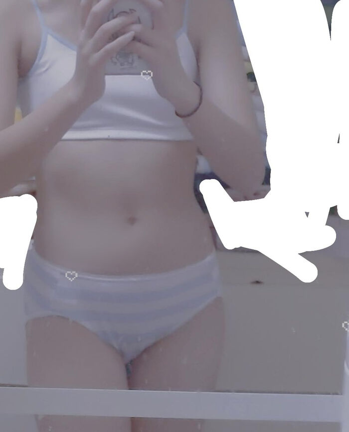 22-year-old female student holding a smartphone with her face and taking a naked hair nude mirror photo 25th image