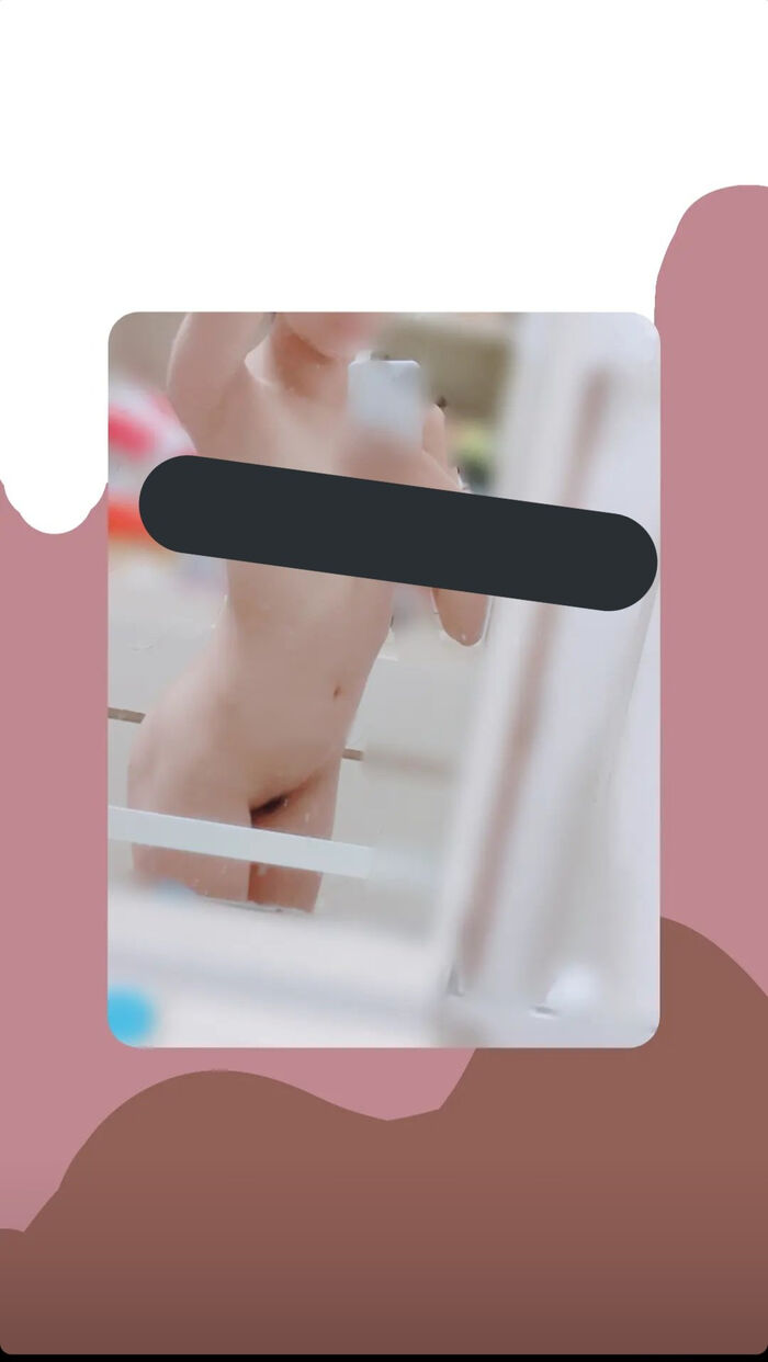 22-year-old female student holding a smartphone with her face and taking a naked hair nude mirror photo 3th image